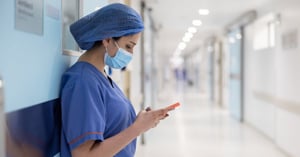 surgeon-texting-outside-the-operating-room